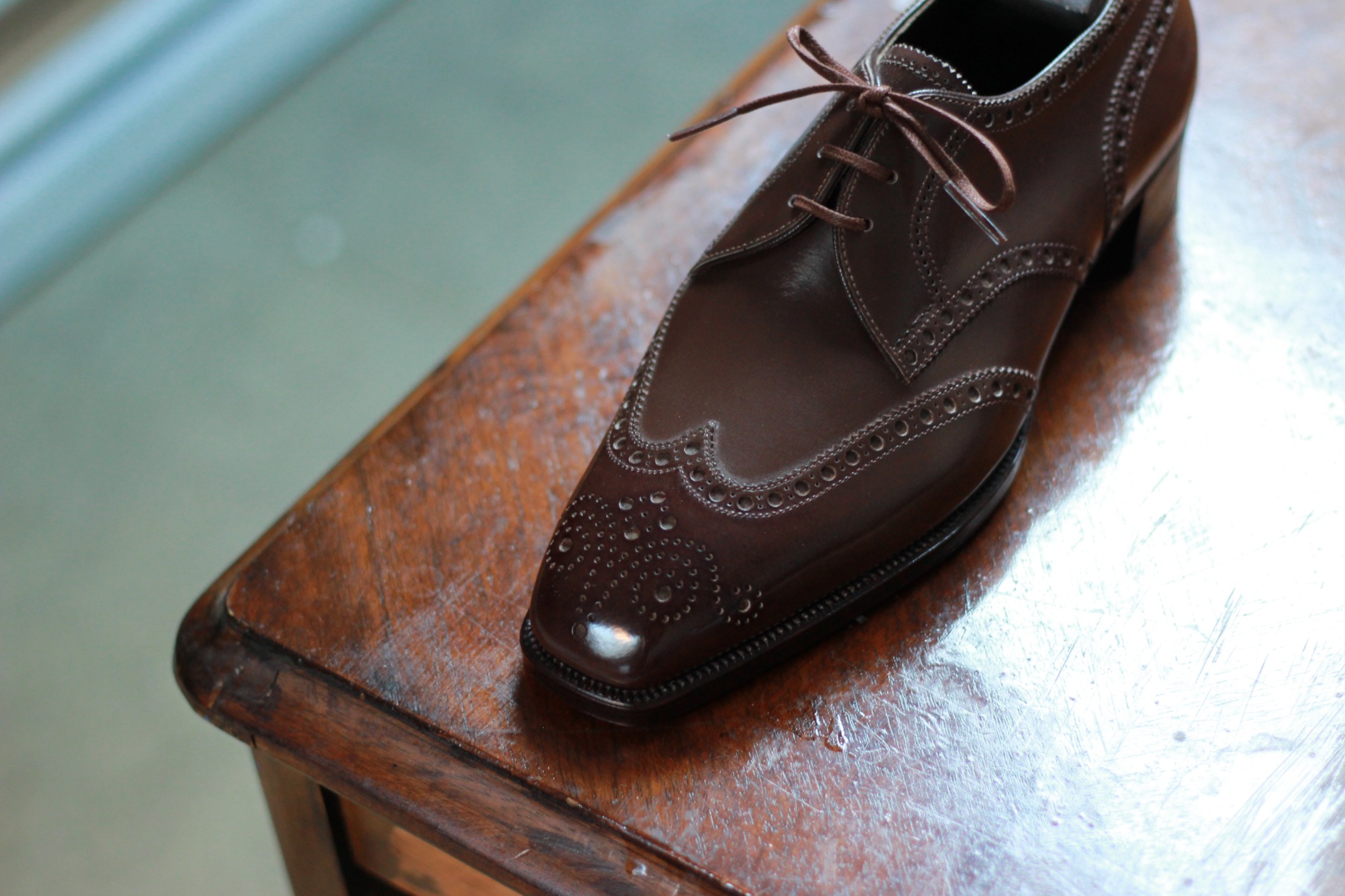 Burgundy and cream brogued ladies shoe detail