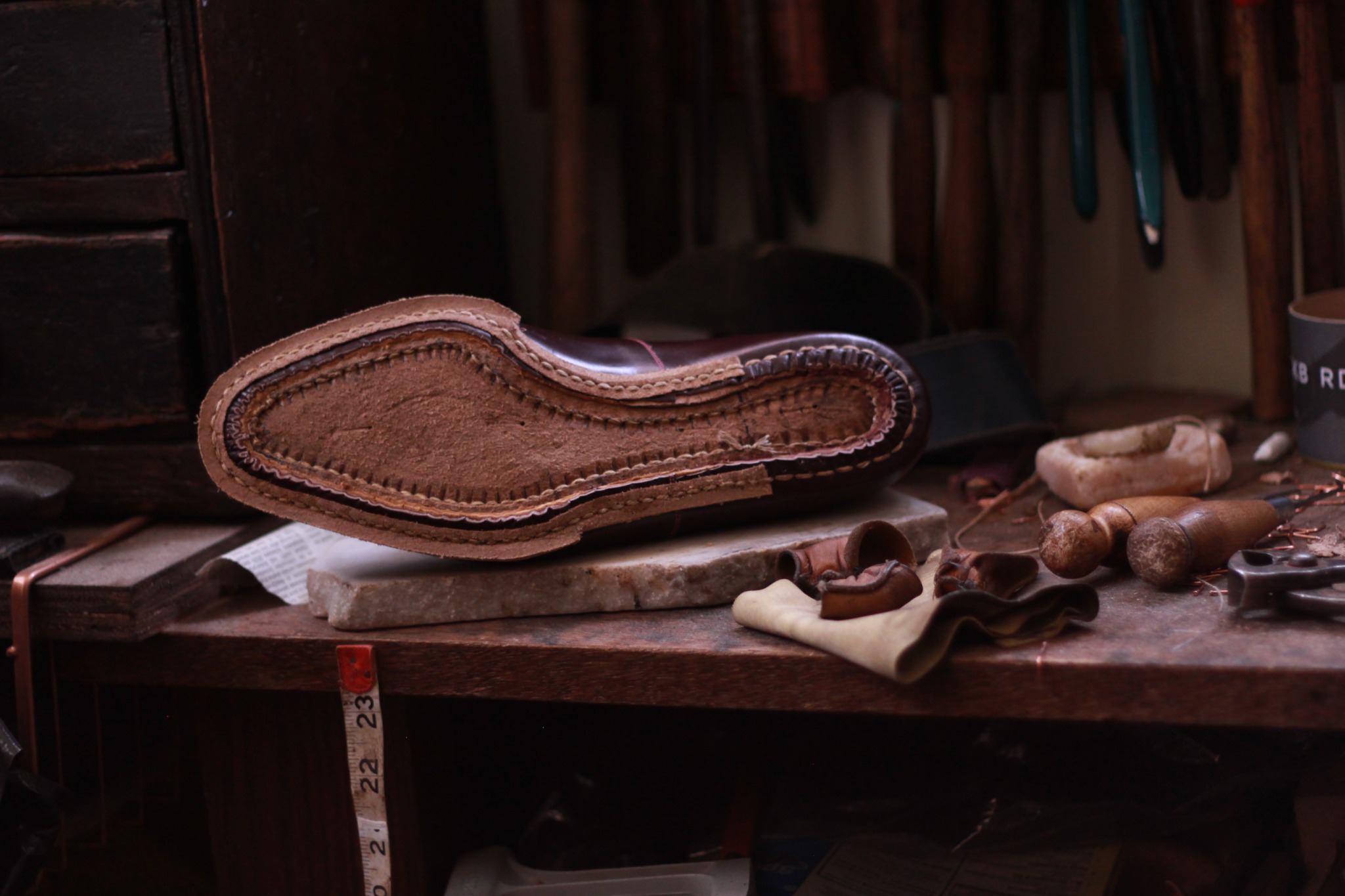 Traditional hand-welted shoe construction on a shoemaking workbench